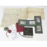 A small collection of military ephemera, including photographs, identity tags, driving licence