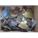 A collection of assorted metal wares, including horse brasses, martingale fittings, army cap badges,