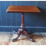 A Victorian mahogany occasional table with a moulded edge, raised on a turned and reeded column on