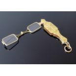 An Antique Yellow Metal Lorgnette with chased foliate decoration, suspension loop and spring