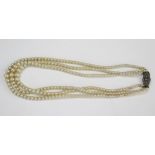 A 15" Three Stand Graduated Pearl Necklace (untested) with continental silver and marcasite clasp (