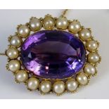 A Victorian Amethyst and Pearl (untested) Brooch in an unmarked gold setting with safety chain,