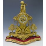 A 19th Century French gilt metal figural mantel clock, the arched and tapering case, surmounted by