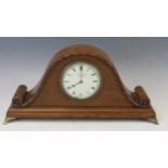 A 1920's oak mantel timepiece of arched outline, with 8.5cm Roman dial, the movement with lever