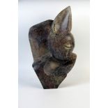 Brighton Sango (1958-1995), abstract sculpture of a fawn, serpentine stone, 38cm.