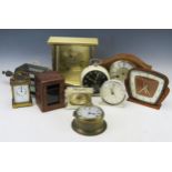 A collection of assorted timepieces, including alarm clock, miniature bulkhead clock, carriage