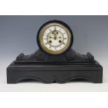 A late Victorian polished slate mantel clock, the drum-shaped case with 11cm Roman dial, the