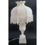 An Alabaster table lamp, of urn-shaped outline with writhen decoration, raised on a stepped a square