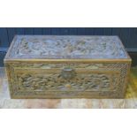 A Chinese carved camphor wood chest of rectangular outline, decorated with dragons chasing pearls of