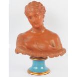 A Watcombe pottery bust of a neoclassical young lady in traditional robes, on a glazed socle base,