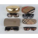 Two pairs of Burberry sunglasses contained in cases, a pair of Helena Rubenstein sunglasses, in a