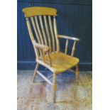 A beech Windsor style elbow chair, with slatted back, solid seat, on ring turned legs linked by