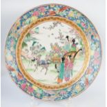 A Chinese Republic porcelain plate, decorated with figures in a deer drawn cart in a garden