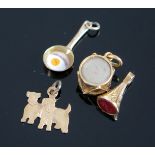 A Frying Pan with Enamel Egg Bracelet Charm (suspender stamped 9ct), Scottie dogs charm (stamped