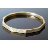 A Large 9ct Gold Decagon Bangle with engine turned decoration, 79mm inside diameter, 14.6g