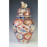 A Japanese Imari porcelain vase and cover of baluster form with co-joined octagonal panels,