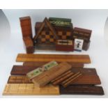 A collection of treen cribbage boards including a triangular cribbage board, folding chess/