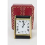 A Boxed Cartier Quartz Easel Back Bedside Clock with alarm in a polished and brushed brass case with