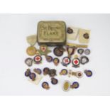 A collection of Industrial Civil Defence Service (ICDS) badges, British red Cross badges, and
