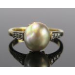 An 18ct Gold Black Pearl and Diamond Ring, London 1977, maker I&MT, 10x9mm pearl which according