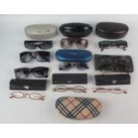 A collection of assorted pairs of sunglasses by various makers including Dior, Oliver, Chloe,