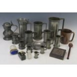 A collection of continental pewter measures, flagon, mugs, printers block, etc