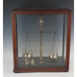 De Grave & Co, London, a pair of lacquered brass laboratory balance scales, with part set of weights