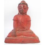 An eastern lacquered figure of a seated Buddha, in traditional crossed leg position, with inset