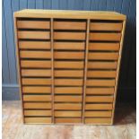 A plywood collector's chest containing thirty six short drawers, 76.5cm wide.