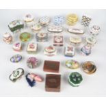 A collection of porcelain and gilt metal mounted pill boxes, patch box, glass paperweight,