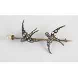 An Antique Rose Cut Diamond and untested Pearl Twin Swallow Brooch with ruby set eyes in an unmarked