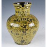 A 20th century pottery Wassail jug, with incised decoration of figures dancing around an apple tree,