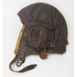 A WWII period RAF B-Type brown leather flying helmet, bears Air Ministry label 22c/65 size 7.1/8-7.