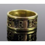 An Unusual Unmarked Gold Band decorated with a band of continuous symbols, 9mm wide, size O, 5.6g