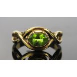A Peridot Dress Ring in an unmarked gold setting, size O.5, 4.8g