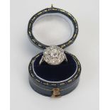 An Early 20th Century Old Cut Diamond Cluster Ring in a precious white metal setting, 13.5mm head,