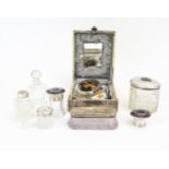 A collection of assorted clear glass and silver mounted dressing table jars and bottles, a silver