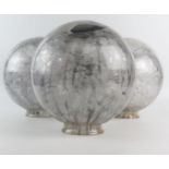 Three smoky glass globe shades, each 23cm diameter.