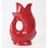 A Dartmouth Pottery gurgle jug, with all red glaze, 18cm high.