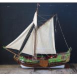 A painted wooden model of a Dutch single masted trader "Ellis 1" with two-tone hull, simulated