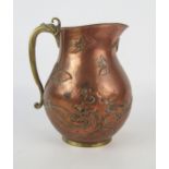 A Japanese brass and copper jug, of ovoid form, with butterfly and waves, with brass circular