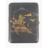 A Komai style damascene iron cigarette case, decorated with a view of Mount Fuji, 9cm long, Meiji/