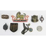 A Third Reich period pressed metal badge with National Emblem, other assorted badges and pendant