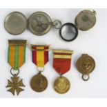 A Dutch Cross of the Four Day Marches, two other medals, an American compass, a magnifying glass,