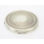 A George V silver compact, maker Hasset & Harper Ltd, Birmingham, 1930, of circular outline with