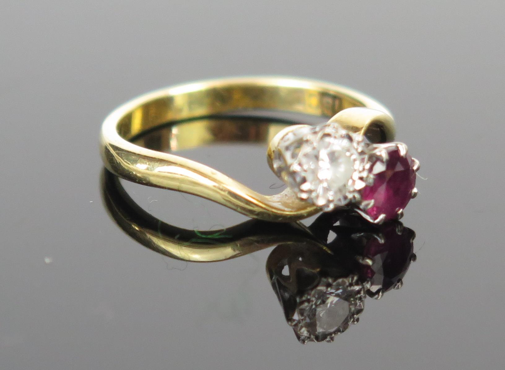 An 18ct Gold, Ruby and Diamond Crossover Ring, ruby c. 4.2mm diam. and diamond c. 4mm, size K, 3.1g - Image 2 of 2