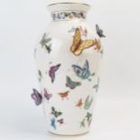 A Franklin Mint porcelain vase, decorated with painted and applied butterflies, 30cm high.