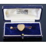 An Antique untested Pearl Set Heart Brooch in an unmarked gold setting and engraved to the