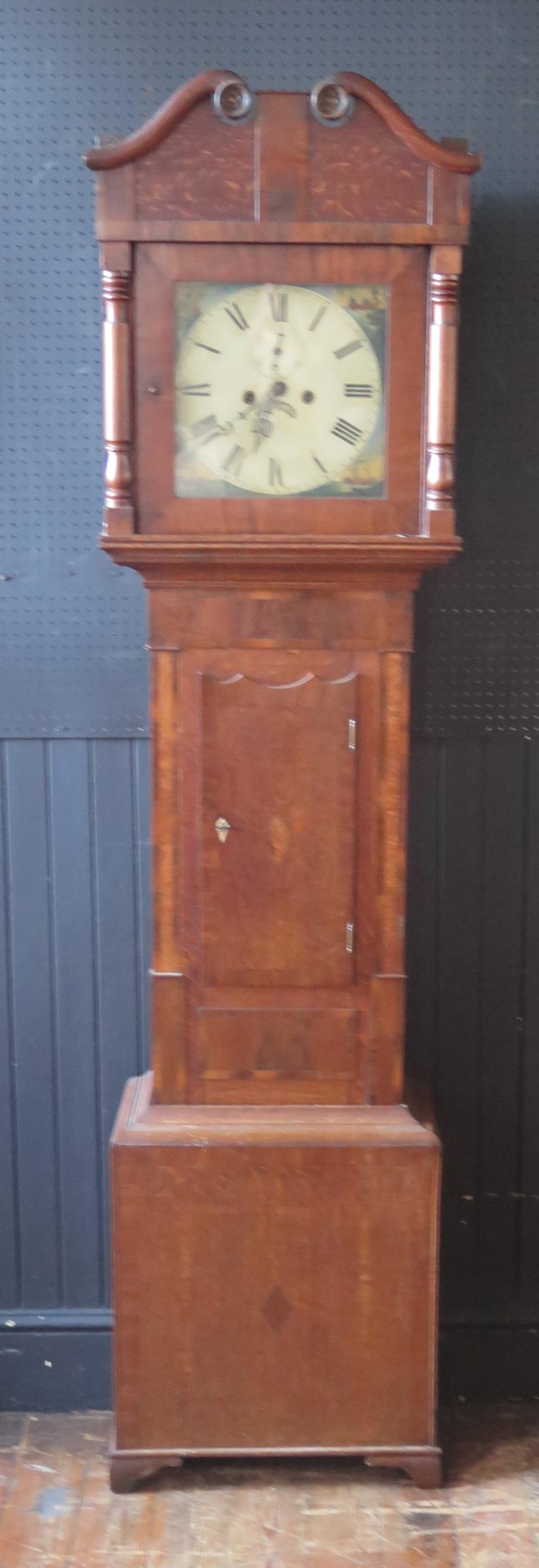 An early 19th century mahogany, oak and crossbanded longcase clock, the arched hood with broken swan