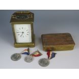 A WWI 1914 Christmas Tin, three commemorative medallions and carriage clock (running)